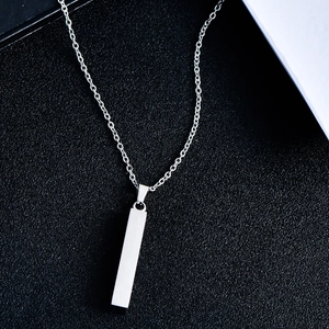 Macro view of vertical bar pendant on minimalist stainless steel necklace chain