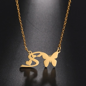 Polished gold butterfly necklace with letter S and heart pendants on black background