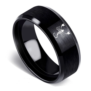 Close-up of black matte stainless steel ring with laser-engraved scorpion and polished edges