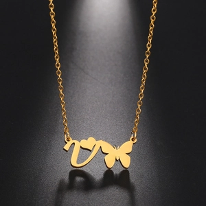 Detailed view of a gold butterfly, heart, and letter V pendant necklace on a black background
