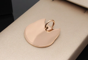 Polished rose gold cat-ear shaped pet ID tag with round metal hanging ring detail