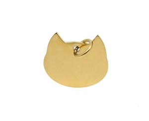 Macro shot of gold-plated cat-shaped metal pet tag with smooth polished edges