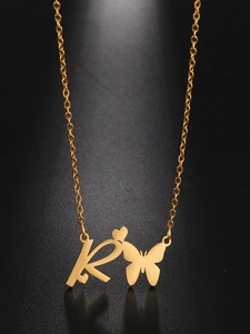 Detailed view of golden necklace with butterfly, heart, and letter R pendant charm