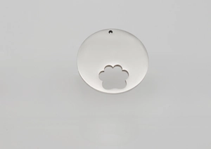 Detailed macro view of a silver stainless steel pet ID tag with a paw print cutout