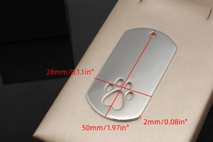 Macro view of rectangular stainless steel pet tag with hollow paw print detail
