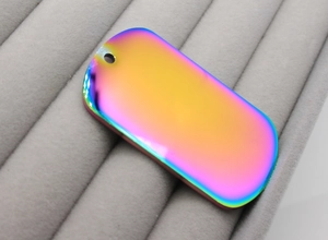 Macro detail of rainbow gradient stainless steel pet ID tag with rounded edges