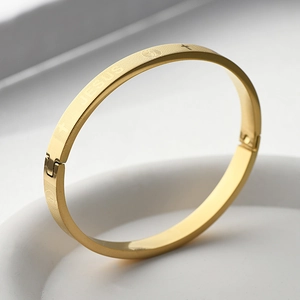 Détail du bracelet religieux en acier doré avec gravure Jesus et fermoir charnière