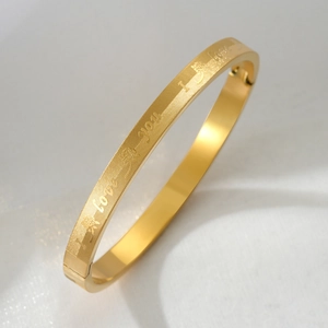 Titanium steel bangle with engraved I Love You text and rose pattern on a gold grid surface