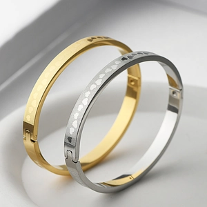 Detailed macro view of heart pattern and brushed mesh texture on titanium steel bangles