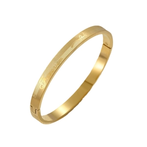 Golden titanium steel bangle with vintage floral engraving and secure snap closure
