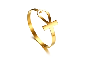Detailed macro view of polished gold Ankh symbol on stainless steel open cuff bracelet