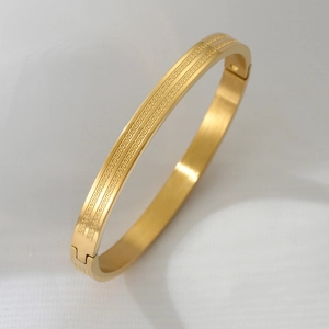 Gold stainless steel hinged bracelet with dual parallel Greek key engraved pattern