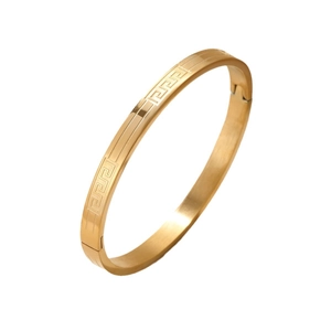 Titanium steel bangle featuring engraved Greek meander pattern in gold finish