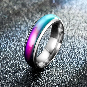 Macro shot of temperature-sensitive color-changing ring on a starry black background