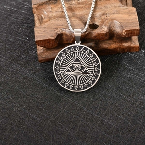 Macro-opname van roestvrijstalen All-Seeing Eye hanger met vrijmetselaarssymbolen