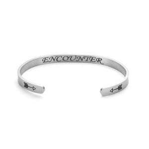 Detail view of silver stainless steel cuff bracelet with ENCOUNTER engraving