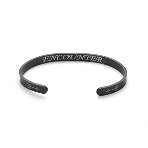 Macro shot of black matte stainless steel cuff bracelet with ENCOUNTER engraving