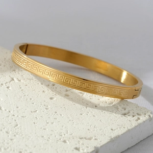 Titanium steel gold bangle featuring classic Greek key pattern and secure side clasp buckle