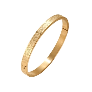Titanium steel bangle for women featuring a gold Greek key pattern and a hinged closure