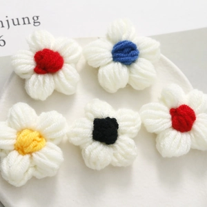 Five handmade crochet puff flowers in white milk cotton yarn with colorful centers