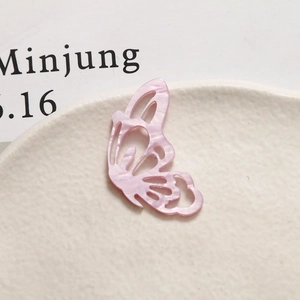 Close-up of pink marble pattern acetate hollow butterfly pendant for jewelry making