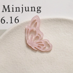 Detailed view of a pink acetate hollow butterfly pendant for DIY jewelry and hair accessories