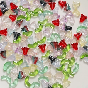 Vue macro de perles de lys en verre translucide et breloques de feuilles pour DIY
