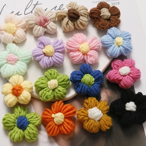 Macro detail of colorful crochet puff flowers for DIY accessories and hair ornaments