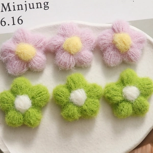 Handmade knitted plush flower accessories in pink and green for DIY clothing crafts