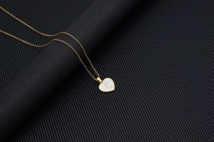 Golden heart-shaped seashell necklace featuring the letter C on a titanium steel chain