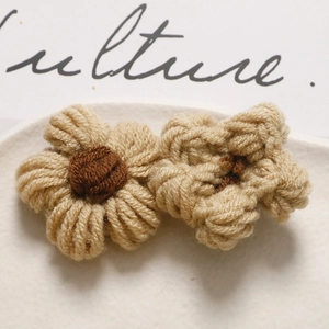 Macro view of handmade crochet puff flowers for DIY hair accessories and crafts