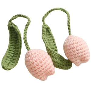 Handmade crochet pink tulip keychains with green leaves on white background