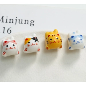 Set of four cute cartoon ceramic cat charms for DIY jewelry and desktop decoration