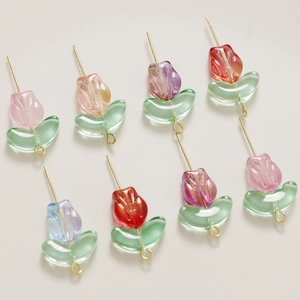 Detailed view of clear glass tulip beads with gold glitter for DIY jewelry making