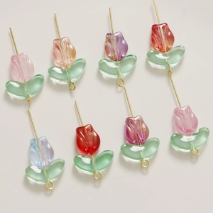 Detailed view of colorful glass tulip beads with golden metal loops for DIY jewelry making