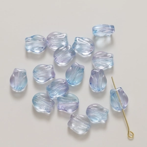 Close-up of translucent glass tulip petals with gold powder and gradient blue-purple tones