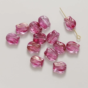 Macro shot of pink gradient glass tulip beads with golden glitter for DIY jewelry making