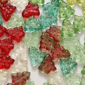 Macro detail of Christmas tree glass charms with gold glitter and 3D textured surface