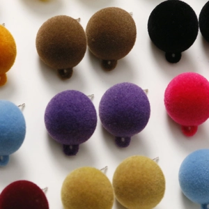 Close-up of colorful flocked round earring pendants with metal hanging hooks for DIY