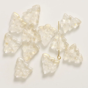 Macro view of iridescent white 3D glass Christmas tree bead with a metal pin for DIY jewelry