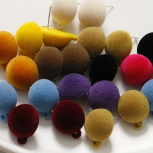 Colorful velvet flocked round earring charms in various vibrant shades on white background