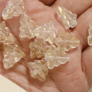 Close-up of translucent yellow resin Christmas tree beads for DIY jewelry making