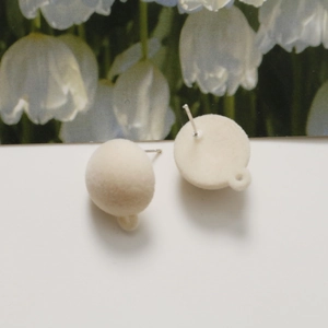 Detailed view of cream white flocked earring posts with metal loop for DIY jewelry making