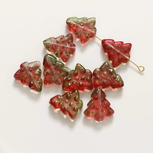 Macro detail of red 3D Christmas tree glass beads with gold pins for DIY jewelry making