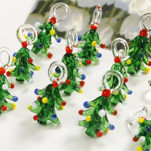 Detailed view of handmade green glass Christmas tree pendants with colorful beads