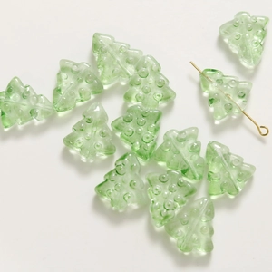 Detail of light green glass Christmas tree beads for DIY earrings and jewelry making