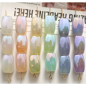 Detailed close-up of rectangular iridescent beads in pastel macaron colors for DIY jewelry