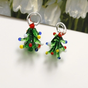 Detail of handmade green glass Christmas tree pendants with colorful beads for DIY jewelry