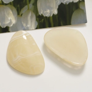 Macro detail of oval resin charms with smoke texture for DIY hair accessories and crafts