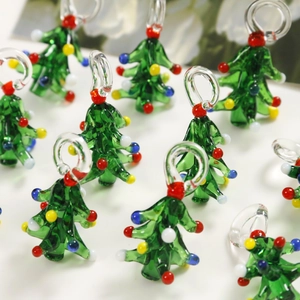 Macro shot of glass Christmas tree charms with colorful beads and transparent loops